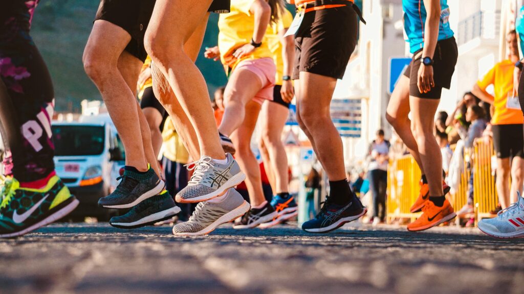 Close-up of a group of runners from the feet down