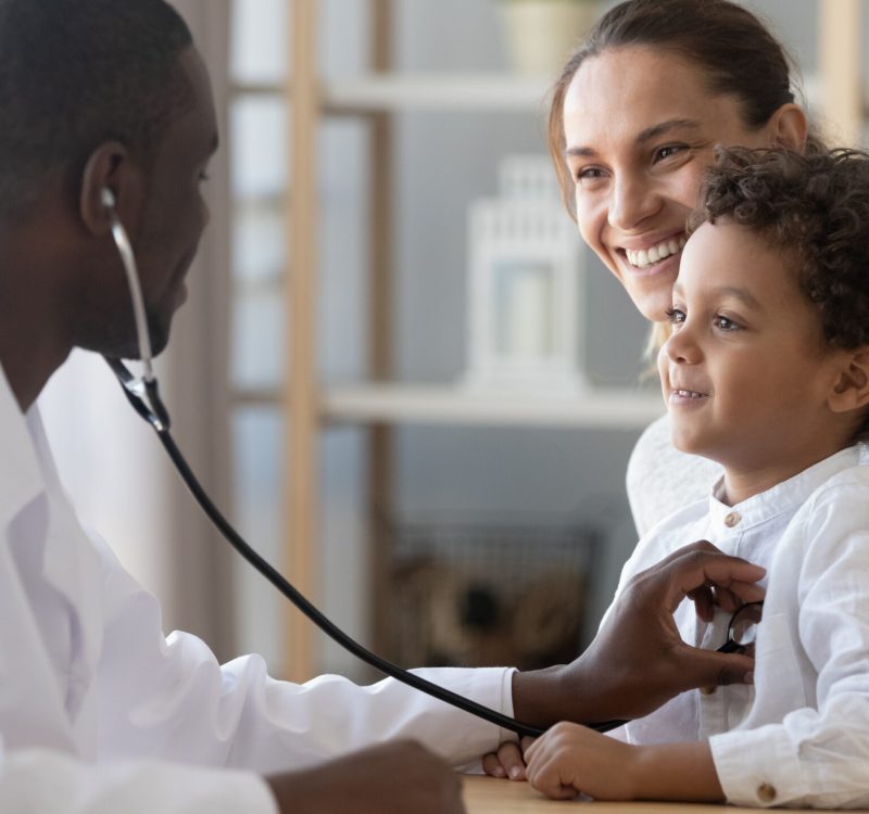 African male pediatrician hold stethoscope exam child boy patient visit doctor with mother, black paediatrician check heart lungs of kid do pediatric checkup in hospital children medical care concept