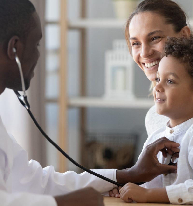 African male pediatrician hold stethoscope exam child boy patient visit doctor with mother, black paediatrician check heart lungs of kid do pediatric checkup in hospital children medical care concept
