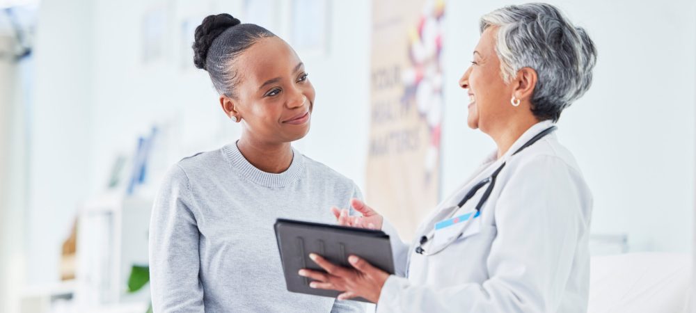 Doctor, women and tablet for happy healthcare, hospital news and support with test results or exam on bed. Senior nurse and patient with digital registration, clinic sign up and medical consultation.