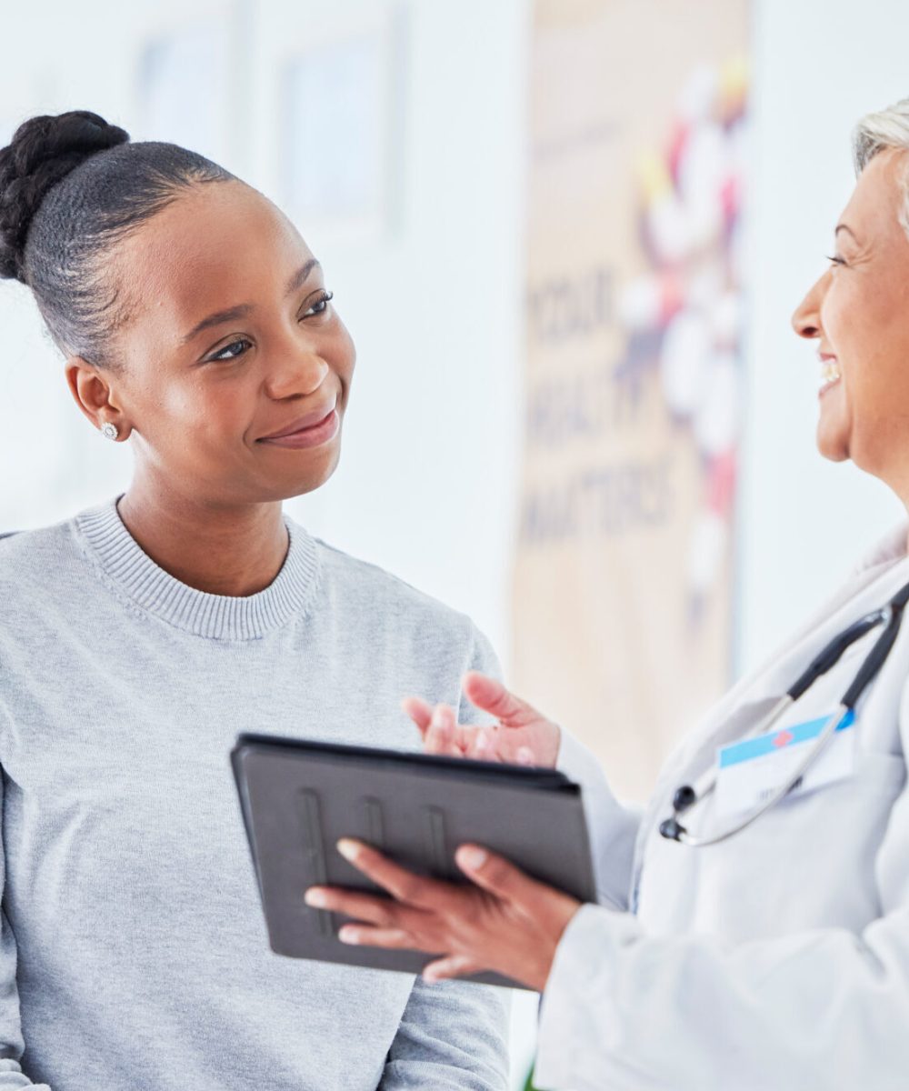 Doctor, women and tablet for happy healthcare, hospital news and support with test results or exam on bed. Senior nurse and patient with digital registration, clinic sign up and medical consultation.