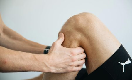 Sports medicine, provider holding a knee