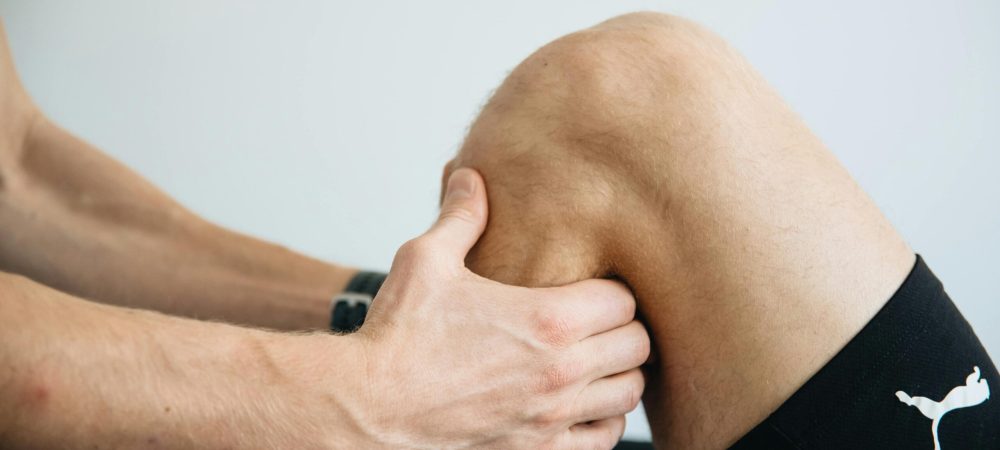 Sports medicine, provider holding a knee