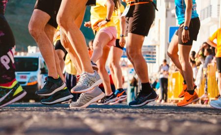 Close-up of a group of runners from the feet down