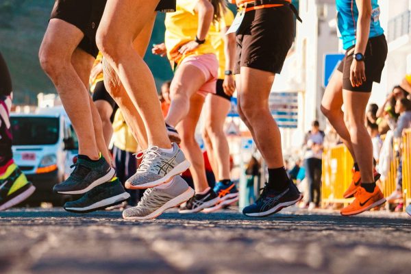 Close-up of a group of runners from the feet down